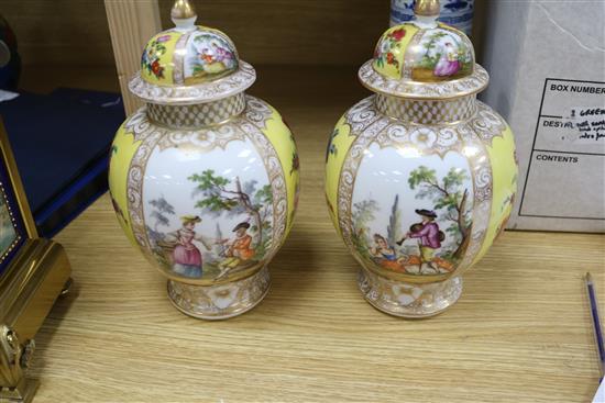 A pair of Dresden vases and covers and two Chinese blue and white vases
